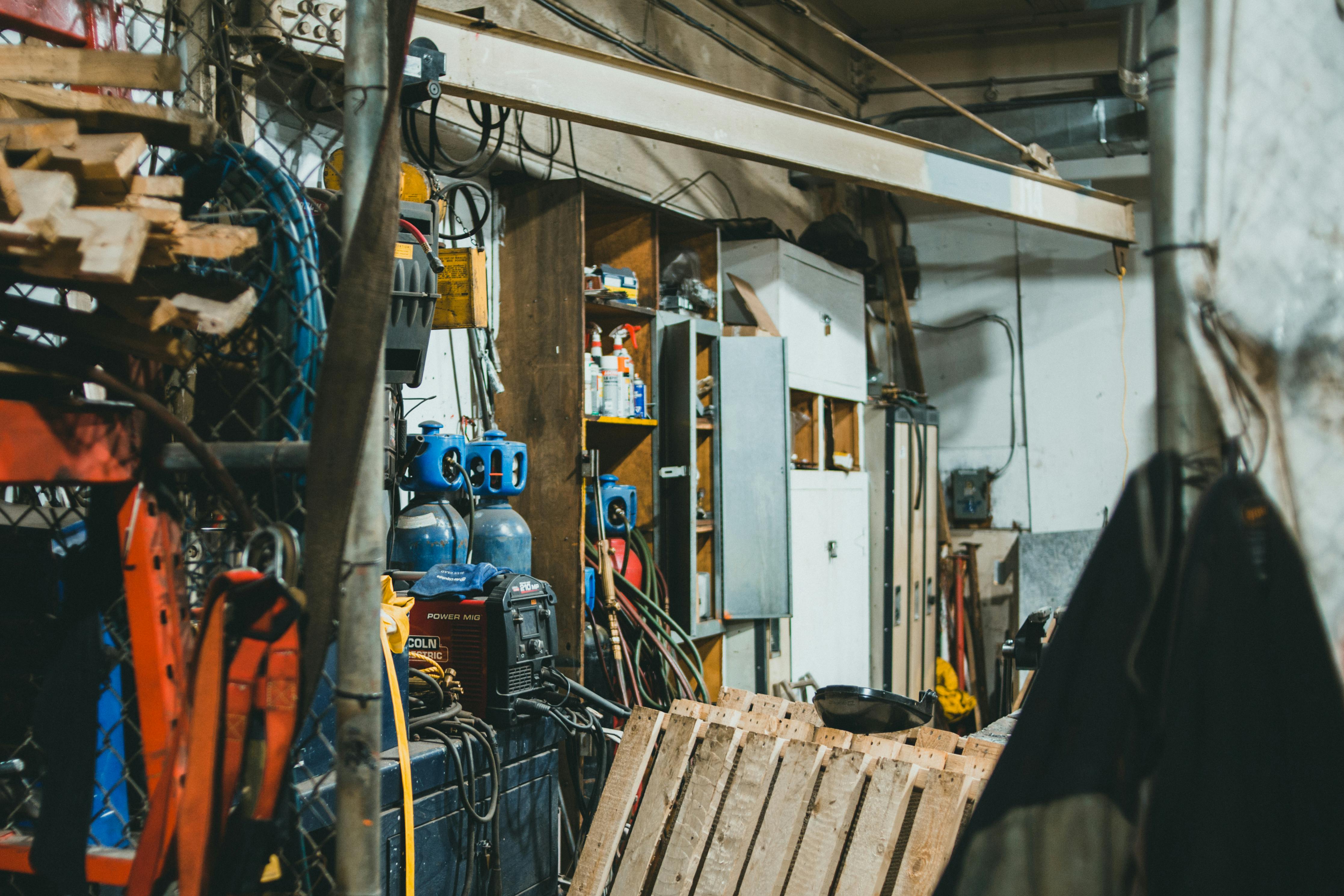 Cluttered workshop with tools, cables, and equipment